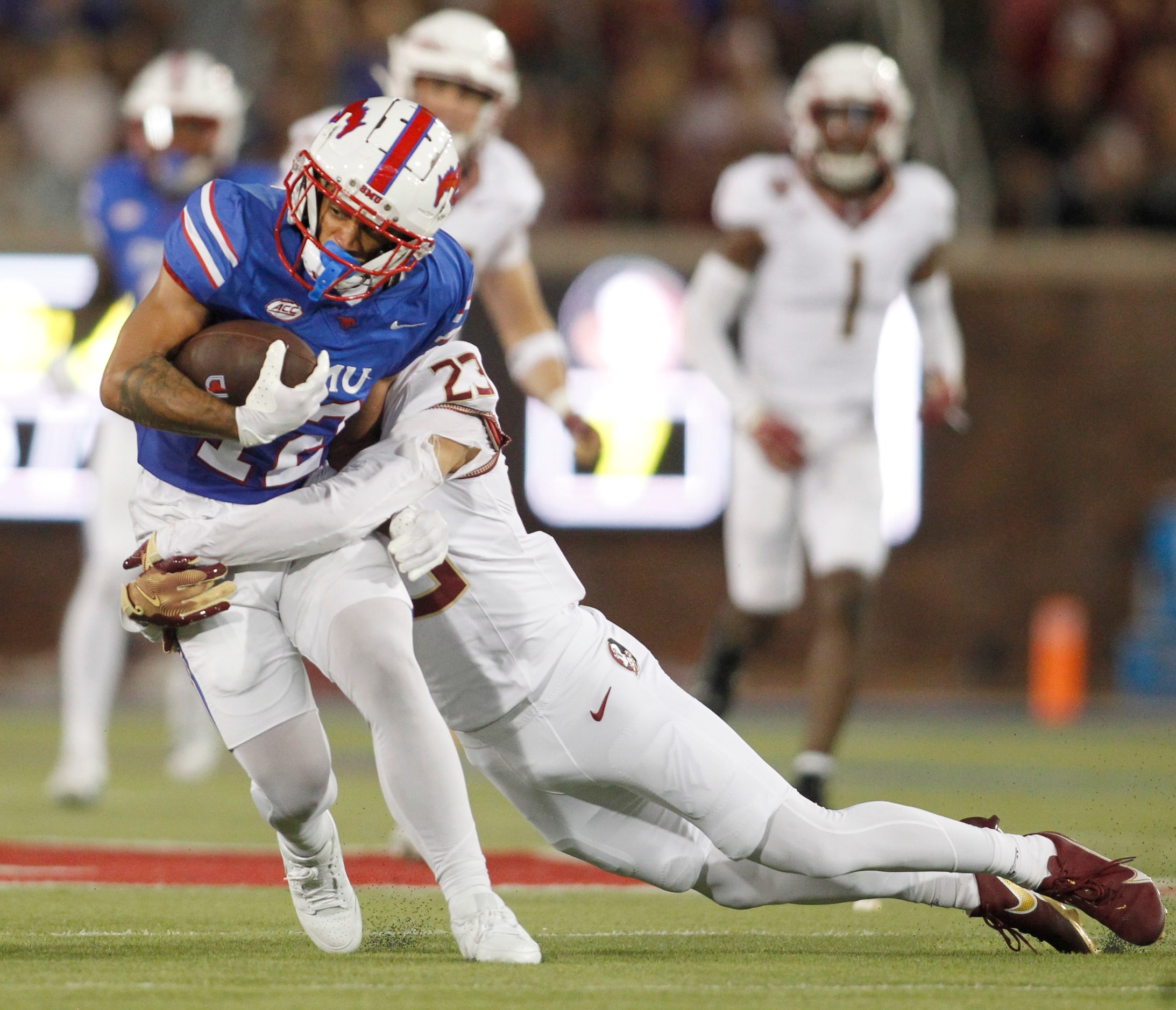 Southern Methodist University receiver Jake Bailey (12) is tackled by Florida State...