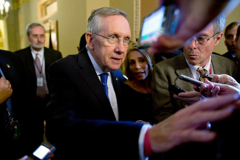 Senate Majority Leader Sen. Harry Reid, D-Nev., is surrounded by reporters after leaving the...