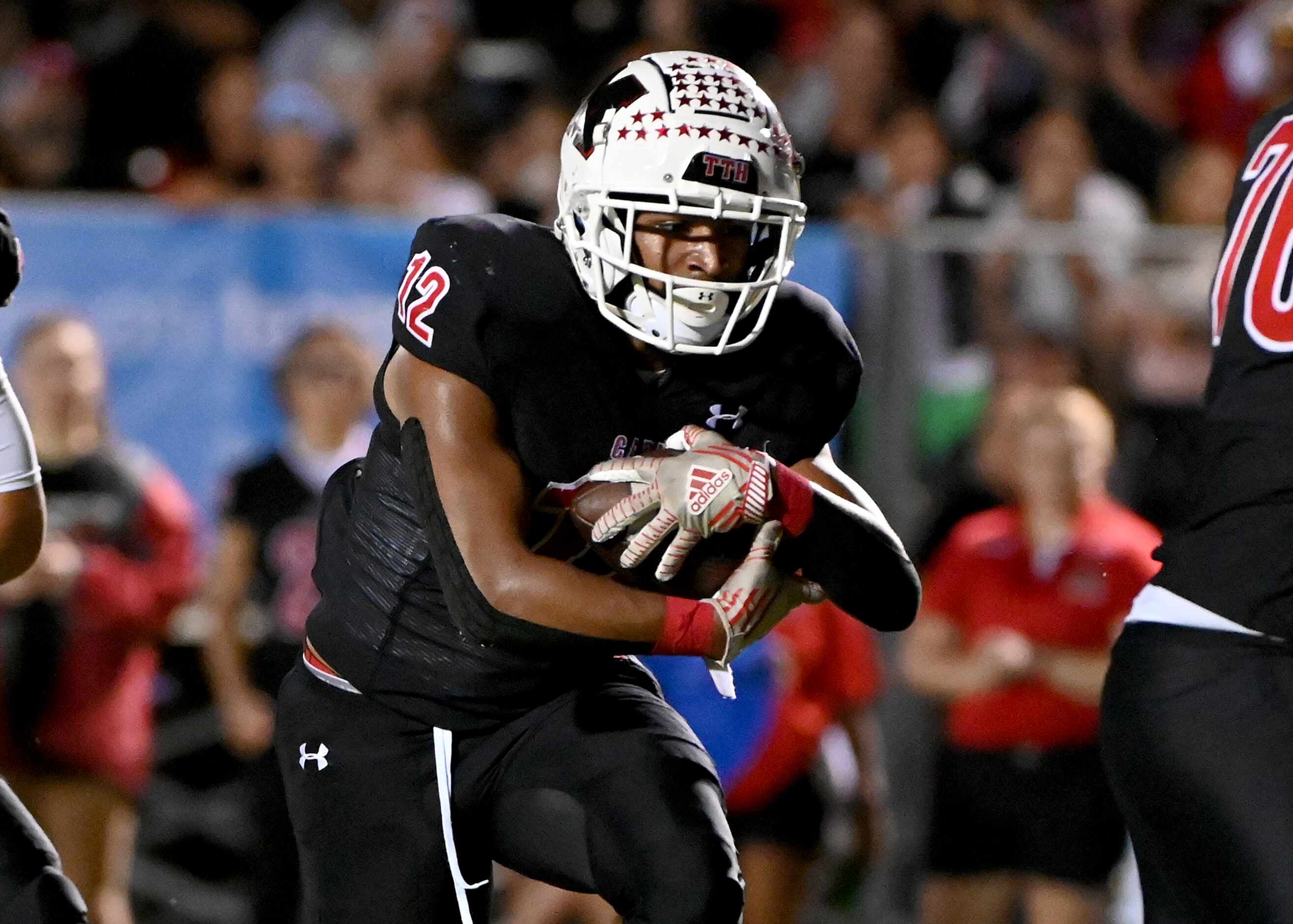 Melissa's Ashton Mitchell-Johnson (12) runs upfield in the first half of a high school...