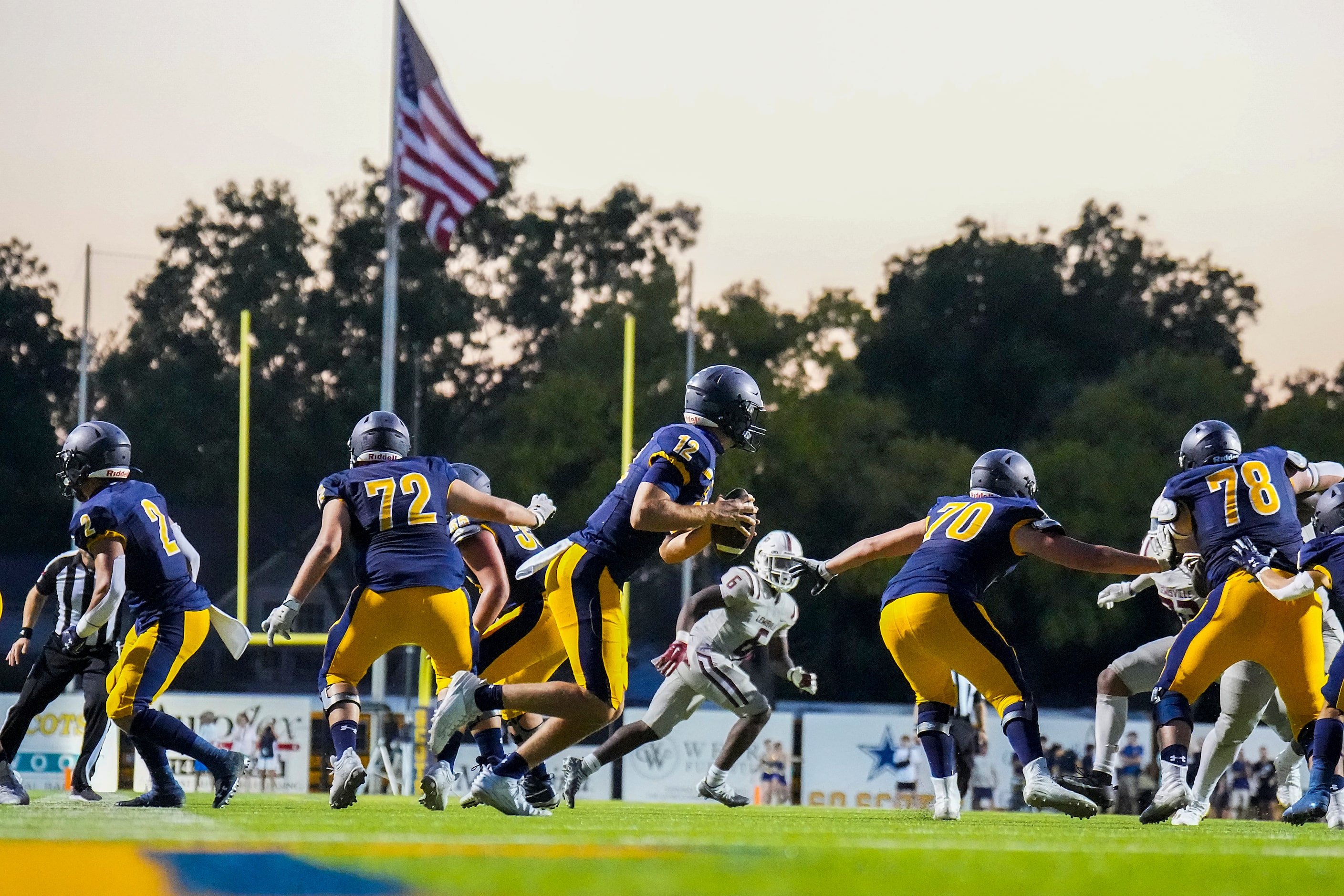 Highland Park quarterback Warren Peck (12) rolls out of the pocket during the first half of...