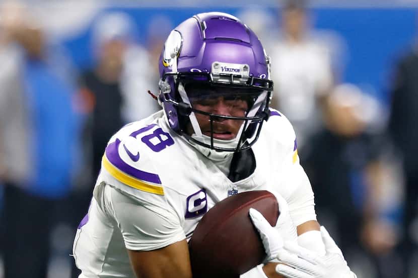 FILE - Minnesota Vikings wide receiver Justin Jefferson carries the ball against the Detroit...