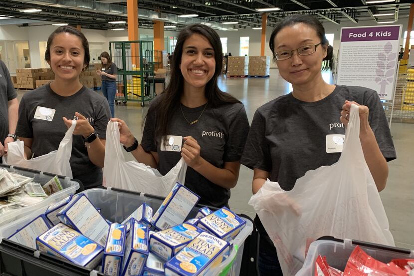 Protiviti Dallas employees pack meals at a recent event as part of its "i on Hunger" program.