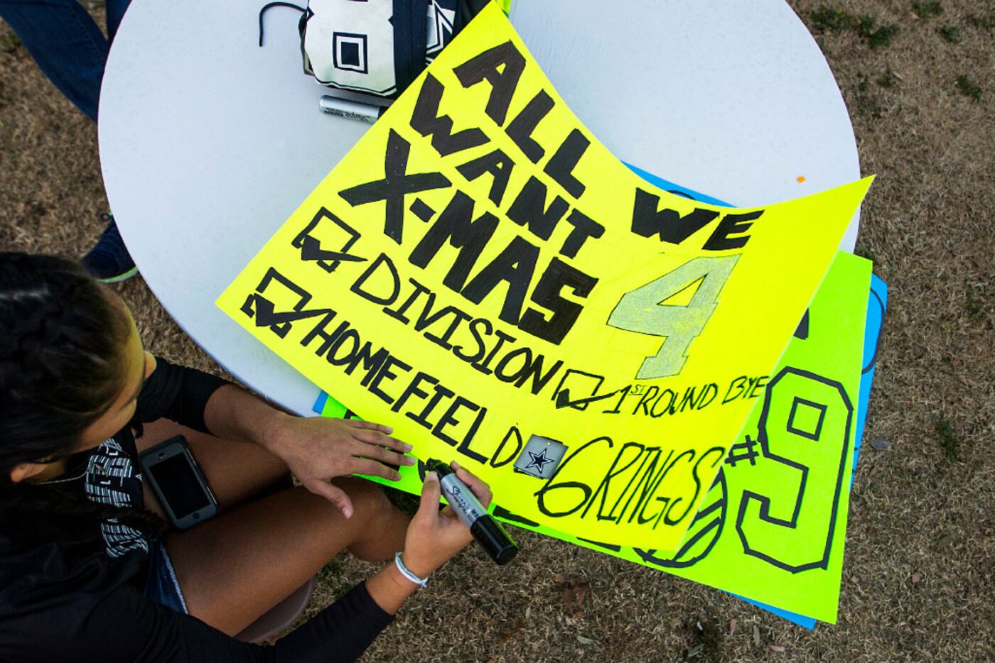 Dallas Cowboys fan Janelle Castro of Brownsville made a sign while tailgating before the...