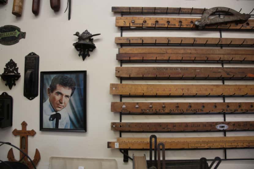 Some of Lynn Dowd's collection of measuring sticks with a signed portrait of at Dowd's...