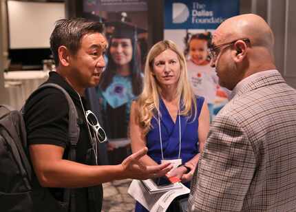 George Tang, left, Dottie Smith, and Aylon Samouha discuss education techniques during the...