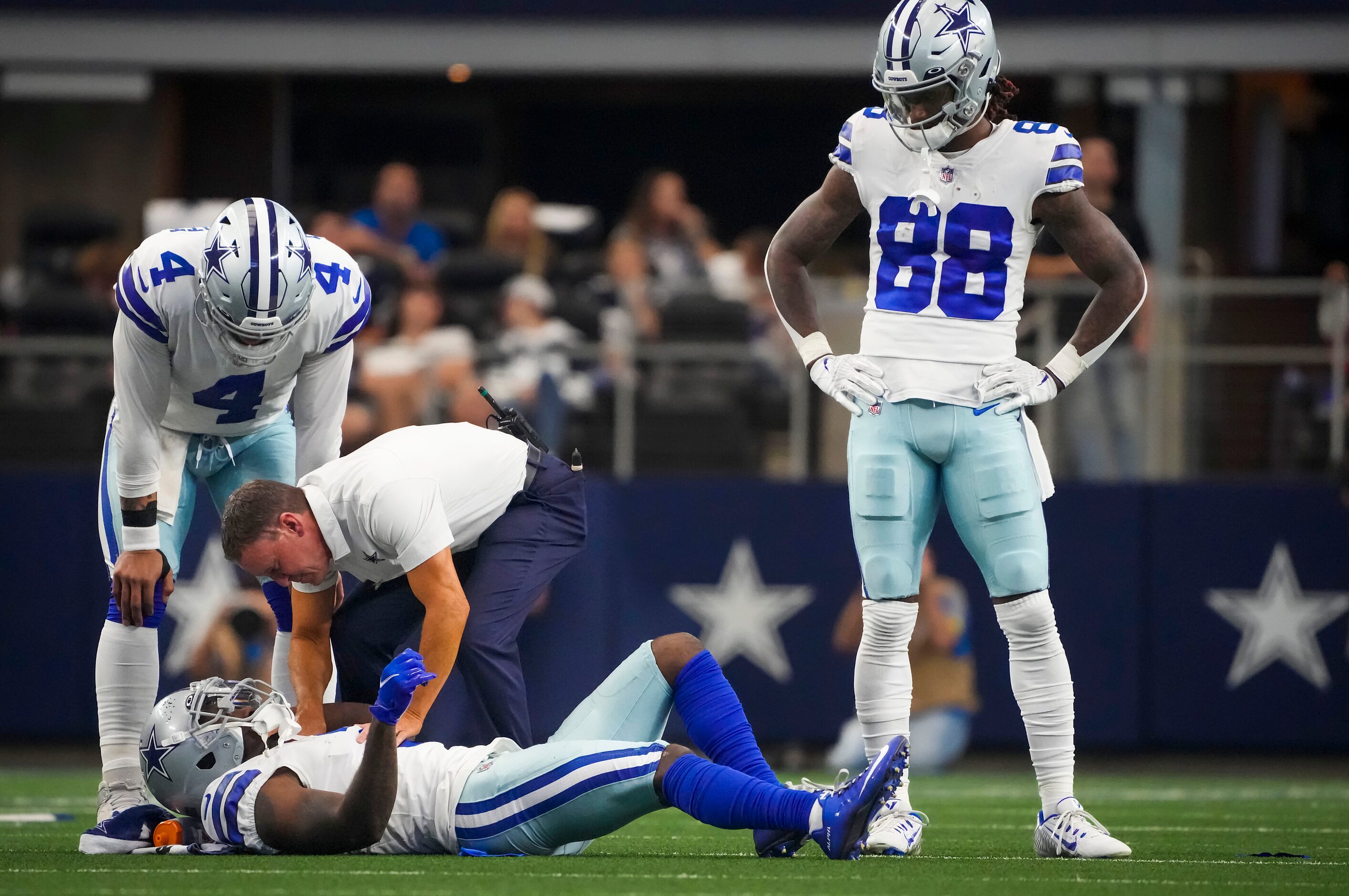 Dallas Cowboys quarterback Dak Prescott (4) and wide receiver CeeDee Lamb (88) look on as...