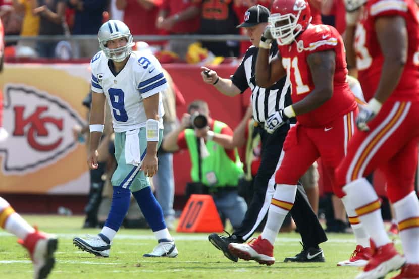 Dallas Cowboys quarterback Tony Romo (9) walks to the sidelines after chasing down Kansas...