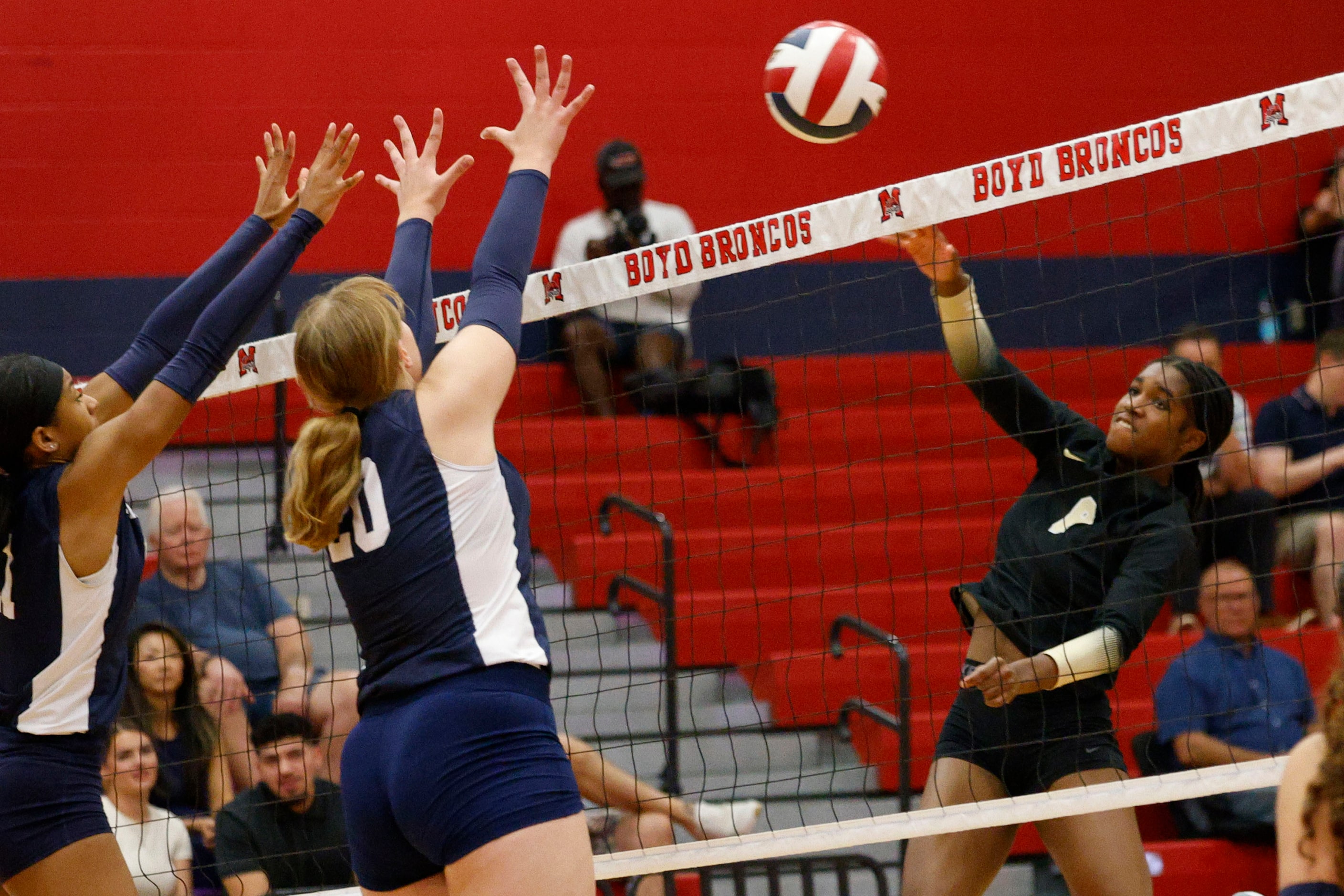 Plano East's Simone Heard (8), right, spikes the ball against McKinney Boyd's Trinity...