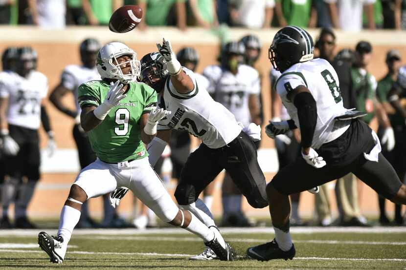 A pass meant for North Texas senior wide receiver Carlos Harris (9) is broken up by Portland...
