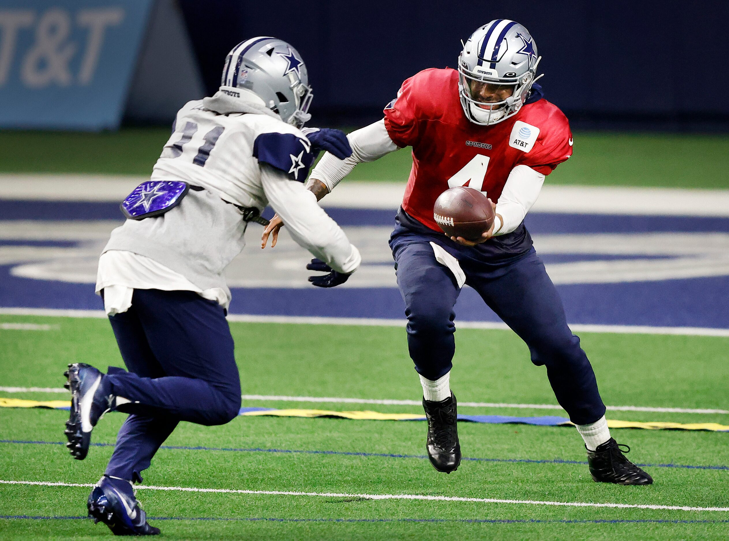 Dallas Cowboys quarterback Dak Prescott (4) hands the ball off to running back Ezekiel...