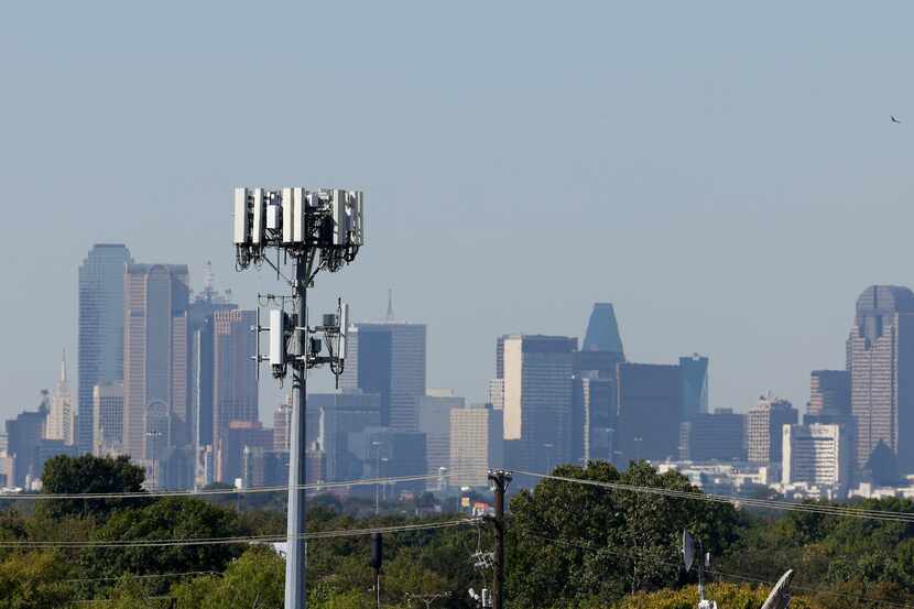 A cell tower overlooking Dallas skyline in Buckner Terrace neighborhood on Wednesday, Oct....