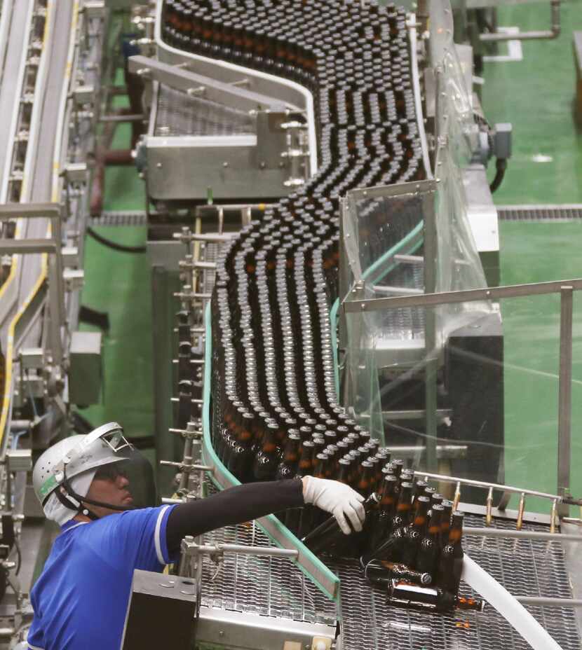 An Asahi Breweries employee works on the production line at a factory in Moriya near Tokyo. 