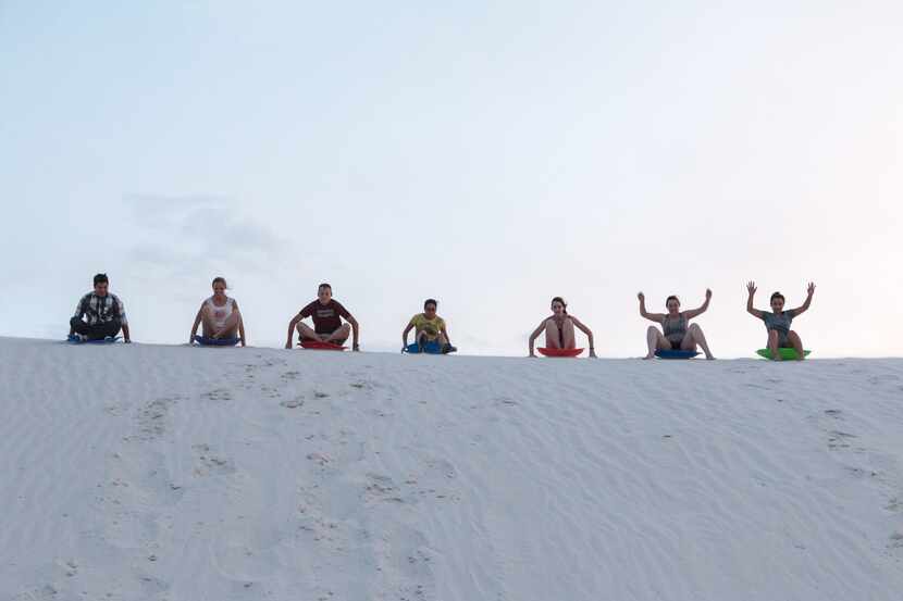 Sledding on the dunes is a popular activity at White Sands National Park.