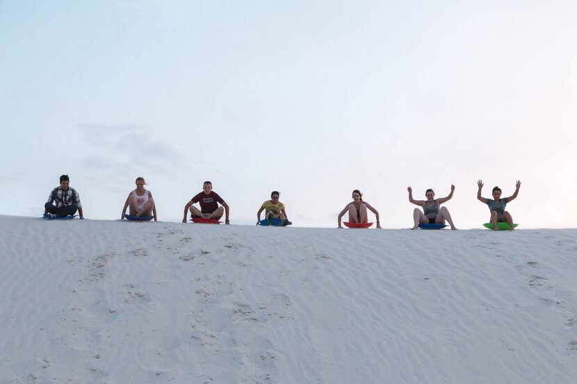 Sledding on the dunes is a popular activity at White Sands National Park.