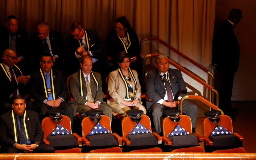 Five flag draped chairs President Barack Obama and First Lady Michelle Obama attend an...