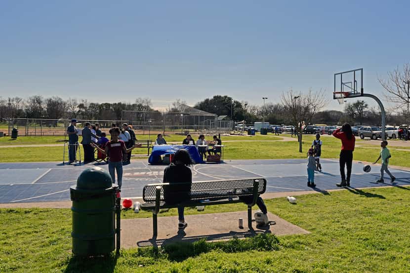 Kids play basketball during the Census Fun Day at Jaycee Zaragoza Park Pavilion in Dallas,...