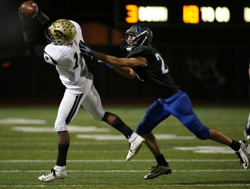 Plano East wide receiver Cameron Moore catches the ball on a third down and 18 yards to go...