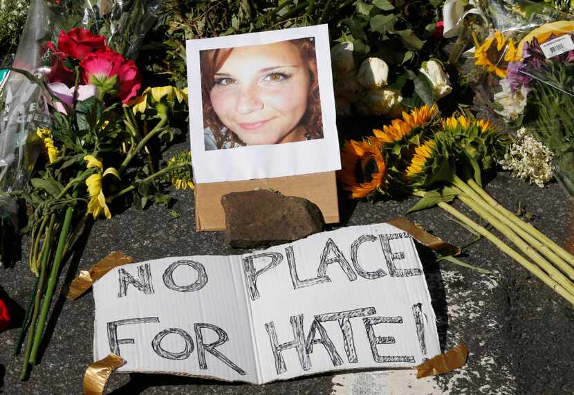 A makeshift memorial of flowers and a photo of Heather Heyer sits in Charlottesville, Va.,...