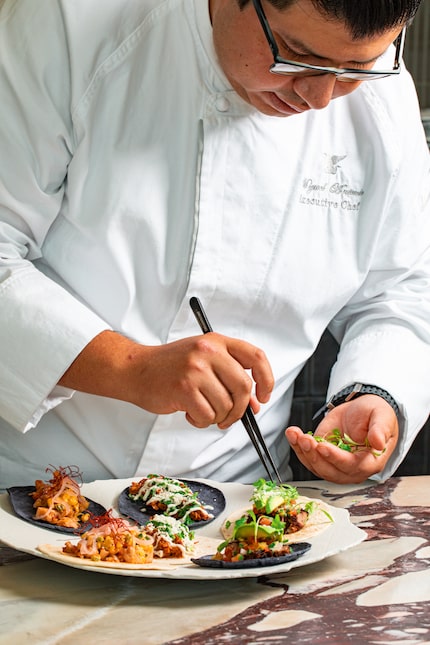 Executive Chef Miguel Antonio finishes a dish at JW Marriott Dallas restaurant Montage. The...