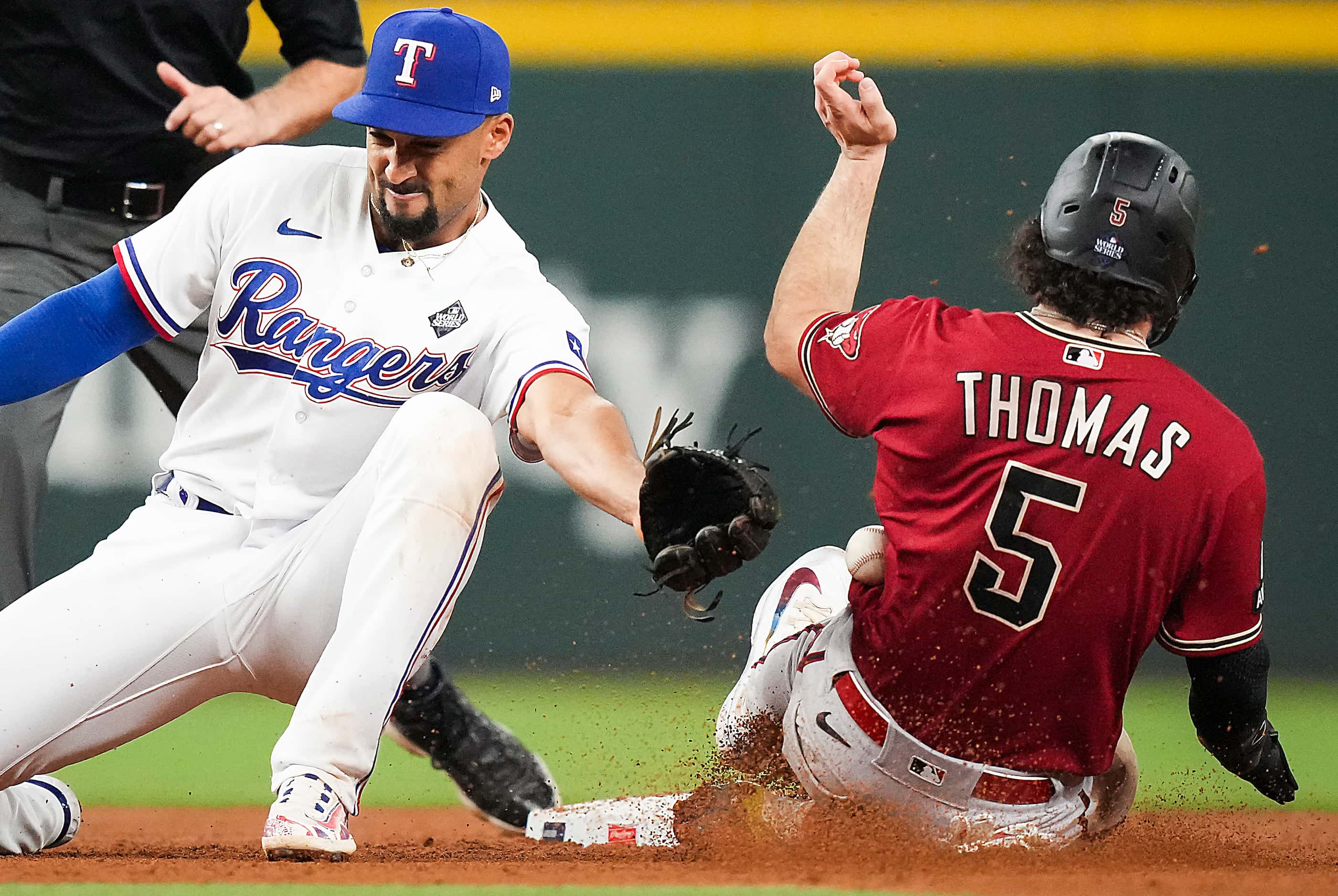 Arizona Diamondbacks' Alek Thomas (5) steals second base as the ball gets away from Texas...