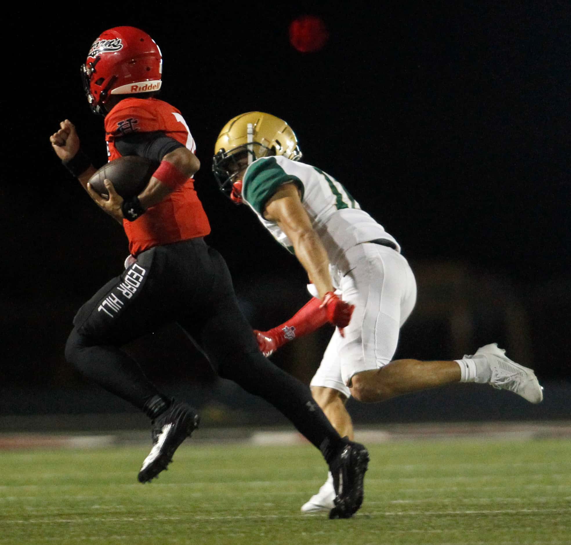 Cedar Hill running back Dayshun Reese-Williams (7), left, tries to elude the defensive...