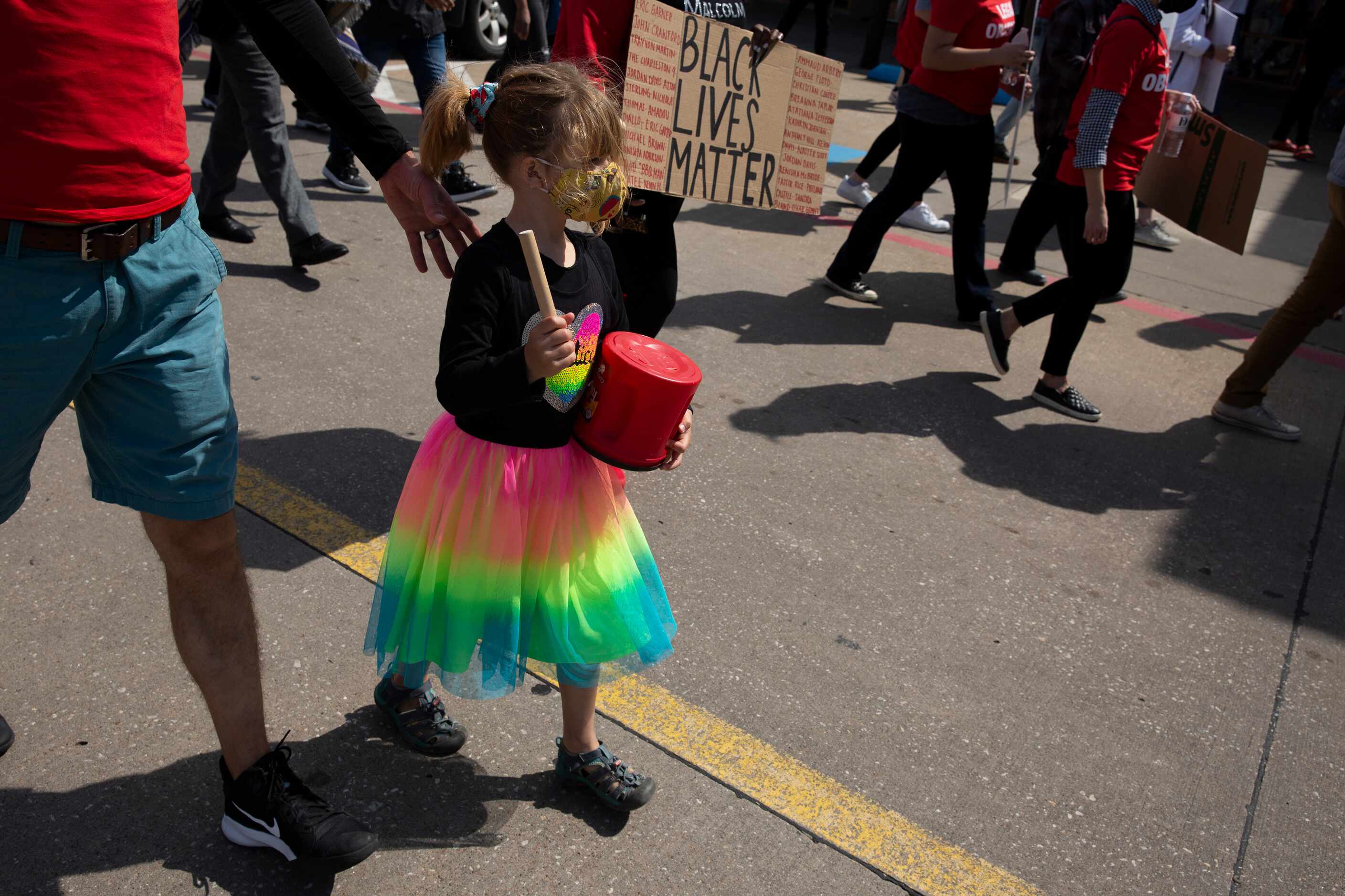 Naomi Ridenour, 6, hits drum to the beat of a chant during a march at the Allen Outlets on...