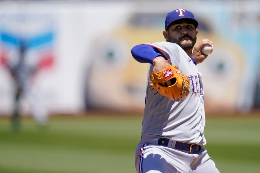 Texas Rangers' Martin Perez pitches against the Oakland Athletics during the first inning of...