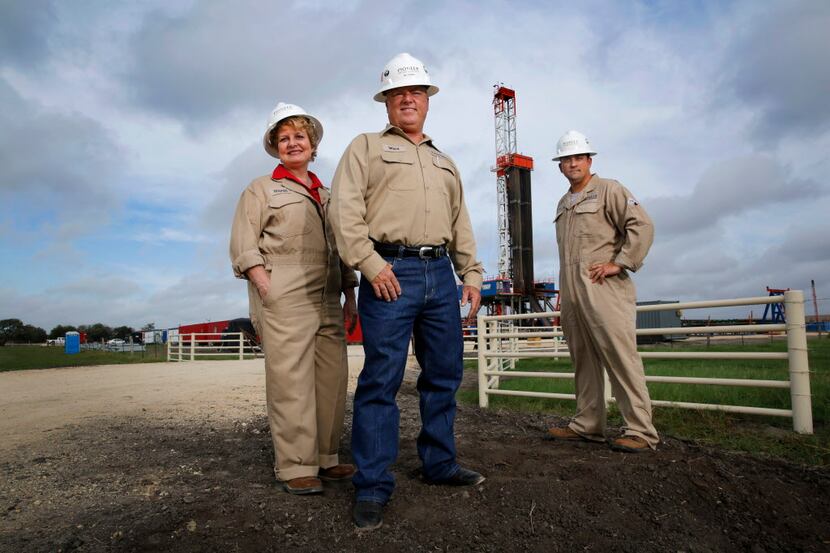 Top 100  Pioneer Natural Resources Senior Field Operations Manager Ward Belanger (center),...