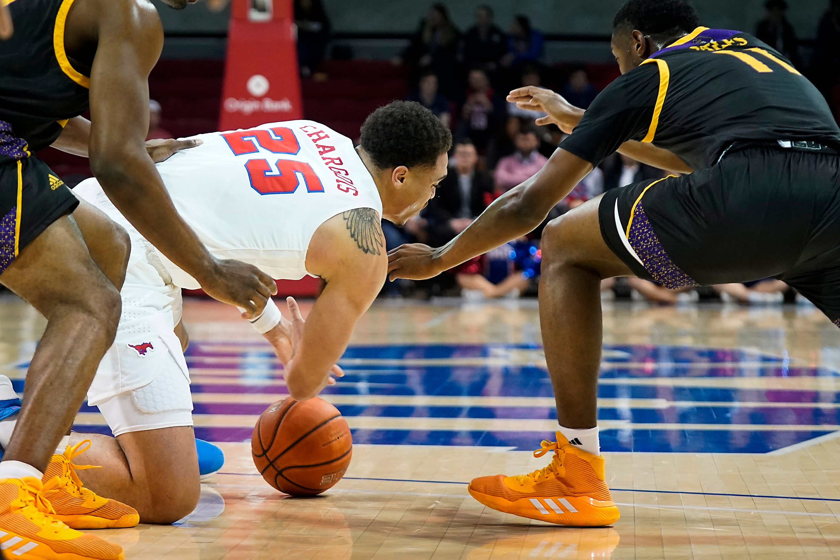 SMU forward Ethan Chargois (25) scrambles for a loose ball against East Carolina guard J.J....