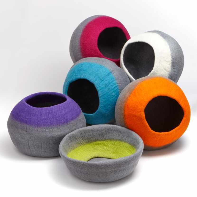 
Both cats and dogs can cuddle in colorful felted-wool caves that can collapse into beds...