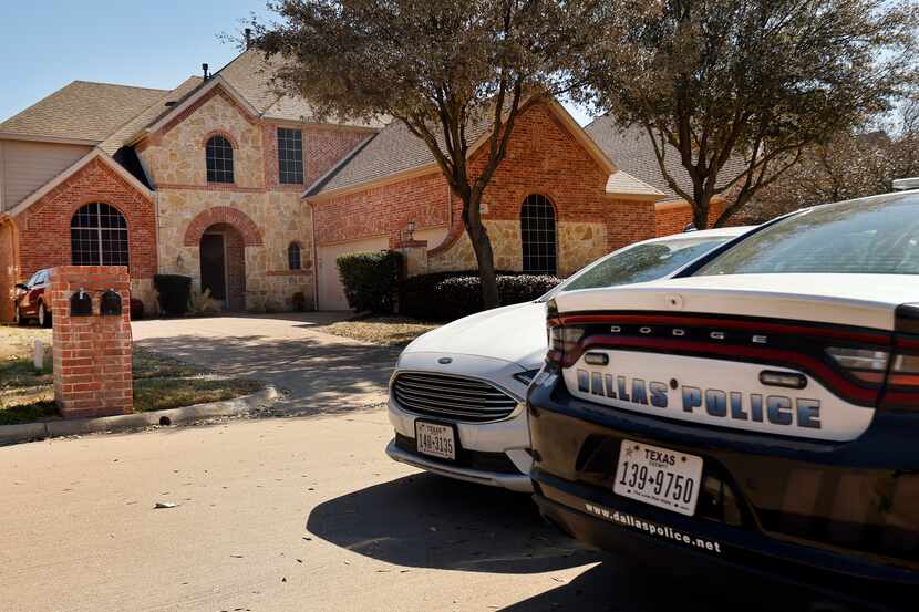 A pair of Dallas Police cars parked outside the home of Dallas officer Bryan Riser in south...
