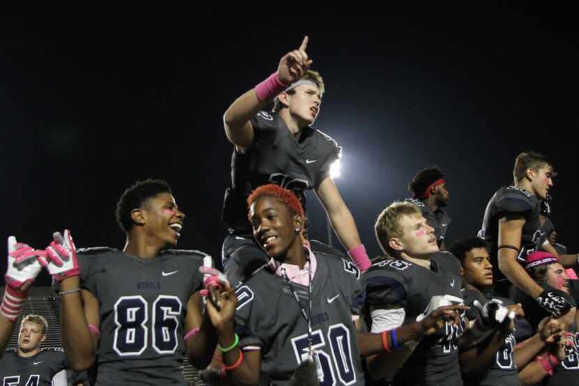 Richland Rebels pause for the playing of their school song following their 38-35 victory...