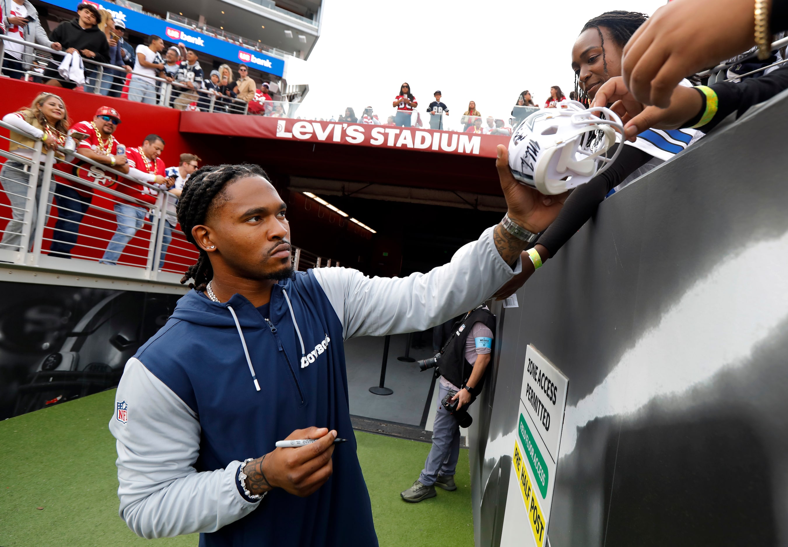 Dallas Cowboys running back Rico Dowdle signs autographs for fans before the team faces the...