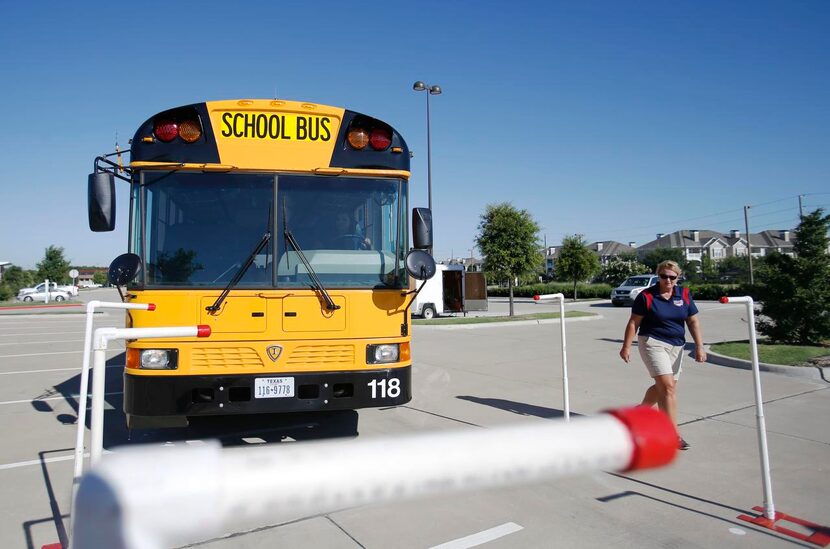 
Bus safety trainer Eileen Targac watches as bus driver Angie Ortiz maneuvers the bus...