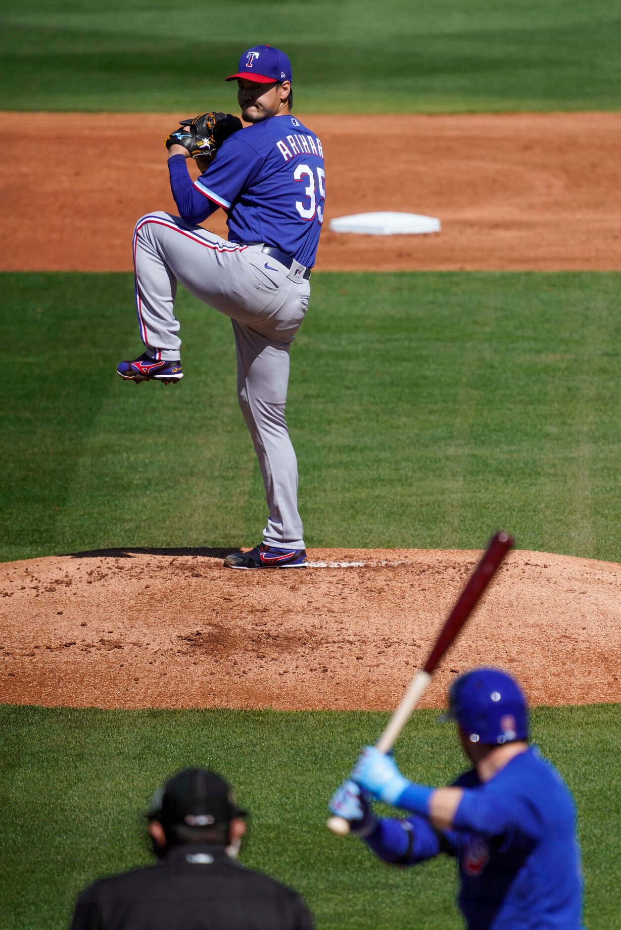 Texas Rangers pitcher Kohei Arihara delivers to Chicago Cubs center fielder Ian Happ during...