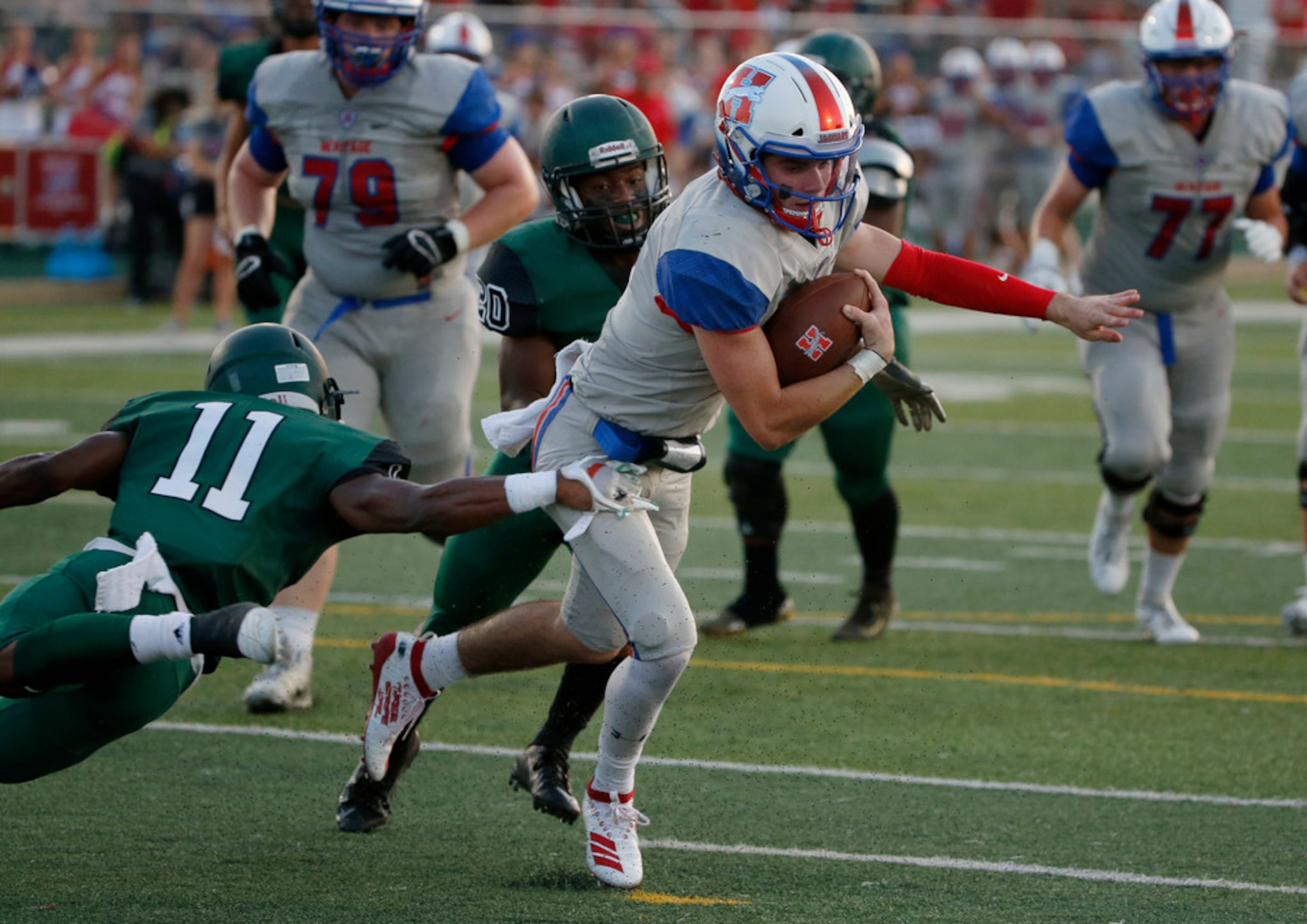 Midlothian Heritage quarterback Cade Sumbler (6) is tackled by Kennedale's Keirahyin Brown...