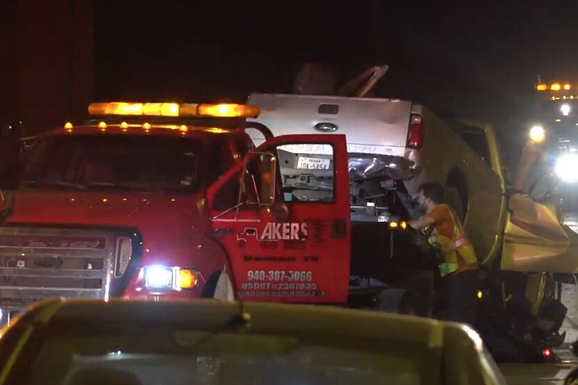 A mangled truck is loaded onto a tow truck in Denton after a fatal single-car crash...
