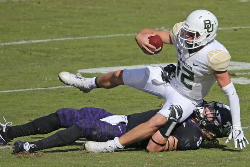 Baylor Bears quarterback Charlie Brewer (12) is sacked by TCU Horned Frogs defensive end Mat...