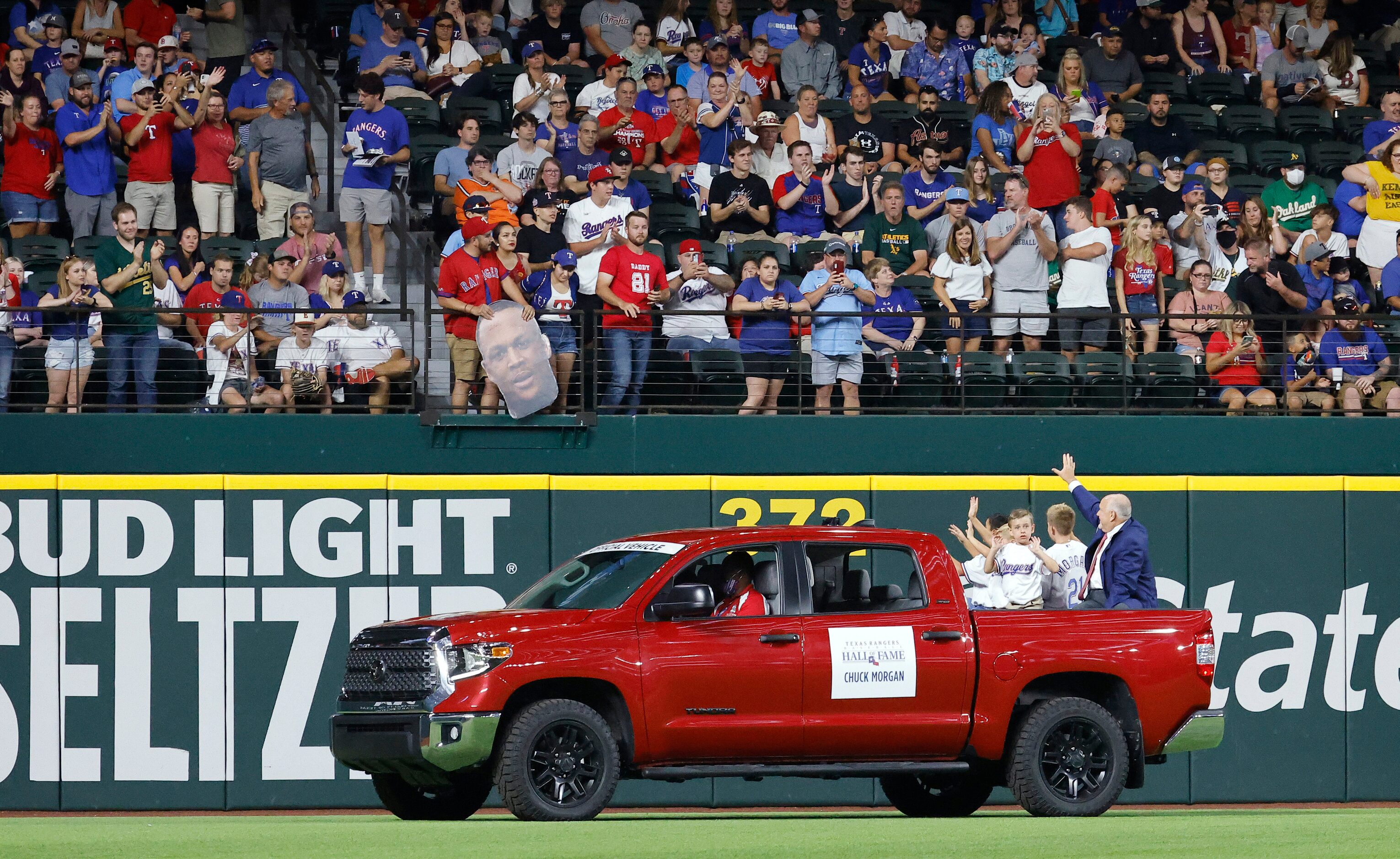 Texas Rangers executive vice president and public address announcer Chuck Morgan (right, in...