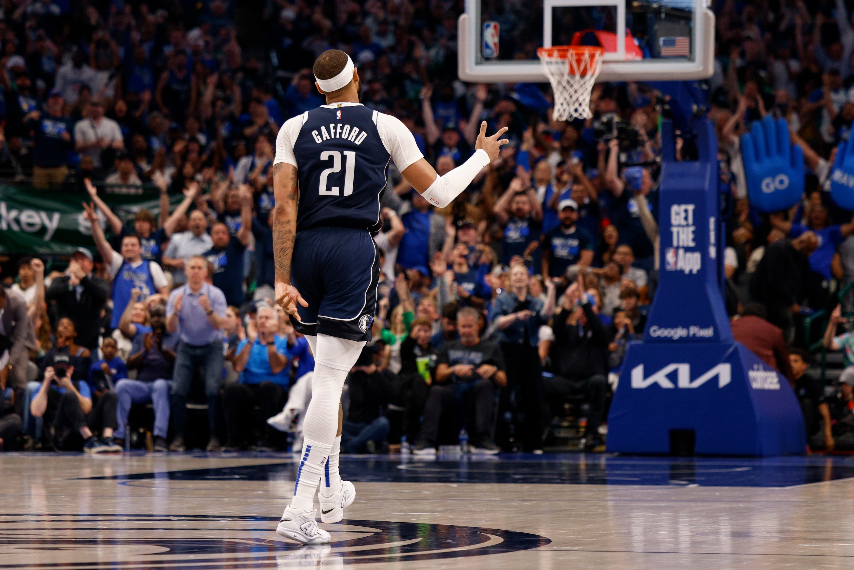 Dallas Mavericks center Daniel Gafford (21) celebrates a three-pointer by guard Kyrie Irving...