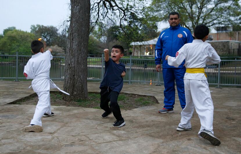 Leonardo Garcia, 6, practices his punches along with Gaviel Espinosa, 7, (left) and...