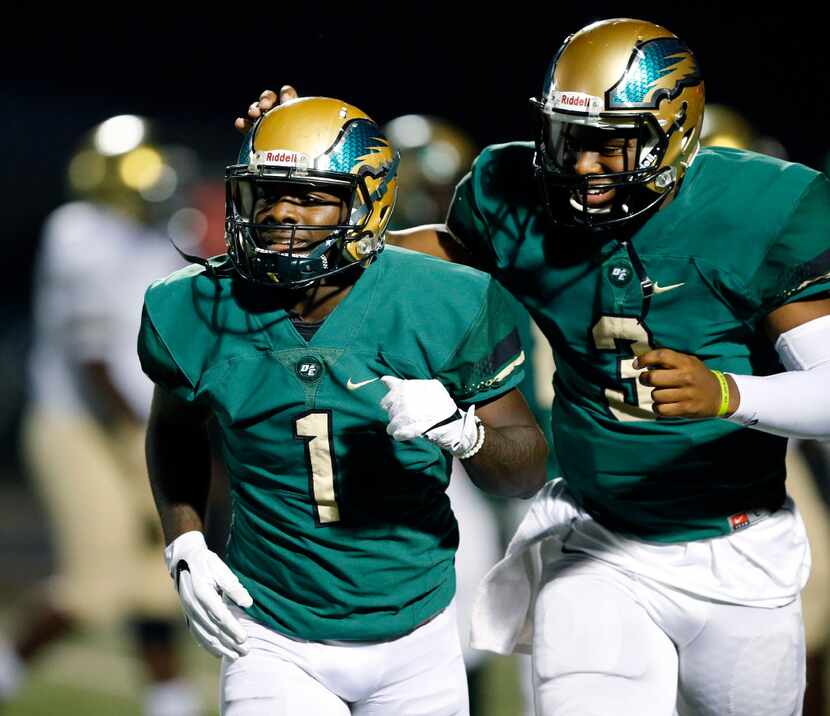 DeSoto wide receiver KD Nixon (1) is congratulated on his first quarter touchdown by...
