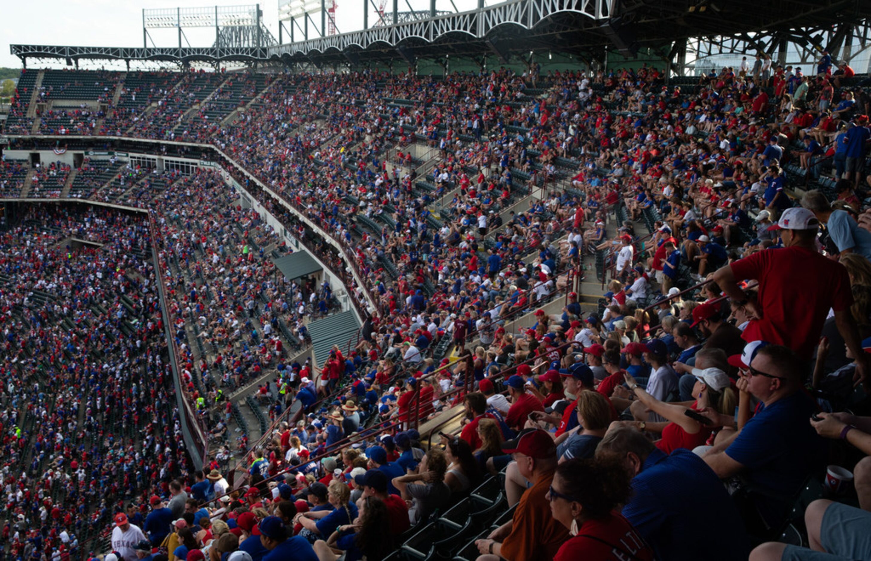 Fans celebrate following the conclusion of the Texas Rangers' last game ever played at Globe...