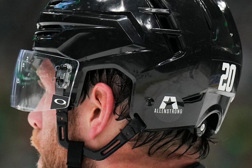Dallas Stars defenseman Ryan Suter (20) wears a helmet with a sticker reading “Allen Strong”...