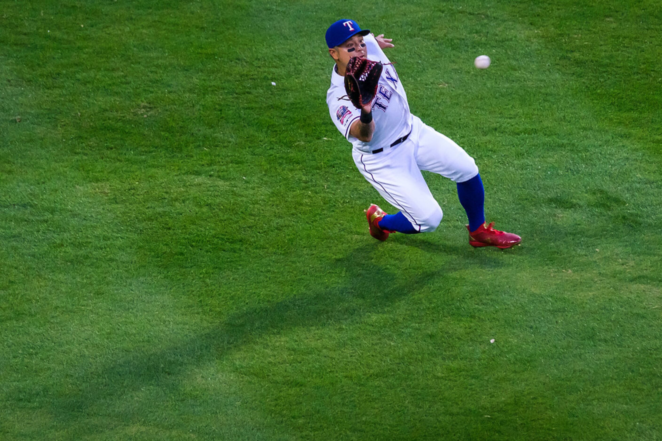 Texas Rangers outfielder Shin-Soo Choo makes a sliding catch to take a hit away from Houston...