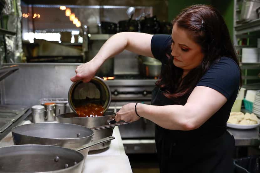 Karin Porter, a chef at The Heights, pours soup into a pan at the Dallas restaurant on Jan....