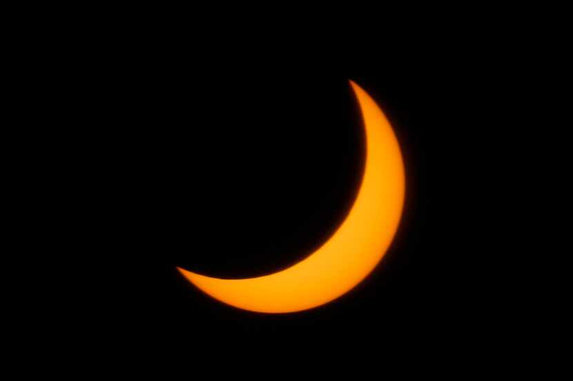At its peak, Monday's eclipse obscured 75 percent of the sun over Dallas. (Tom Fox/Staff...