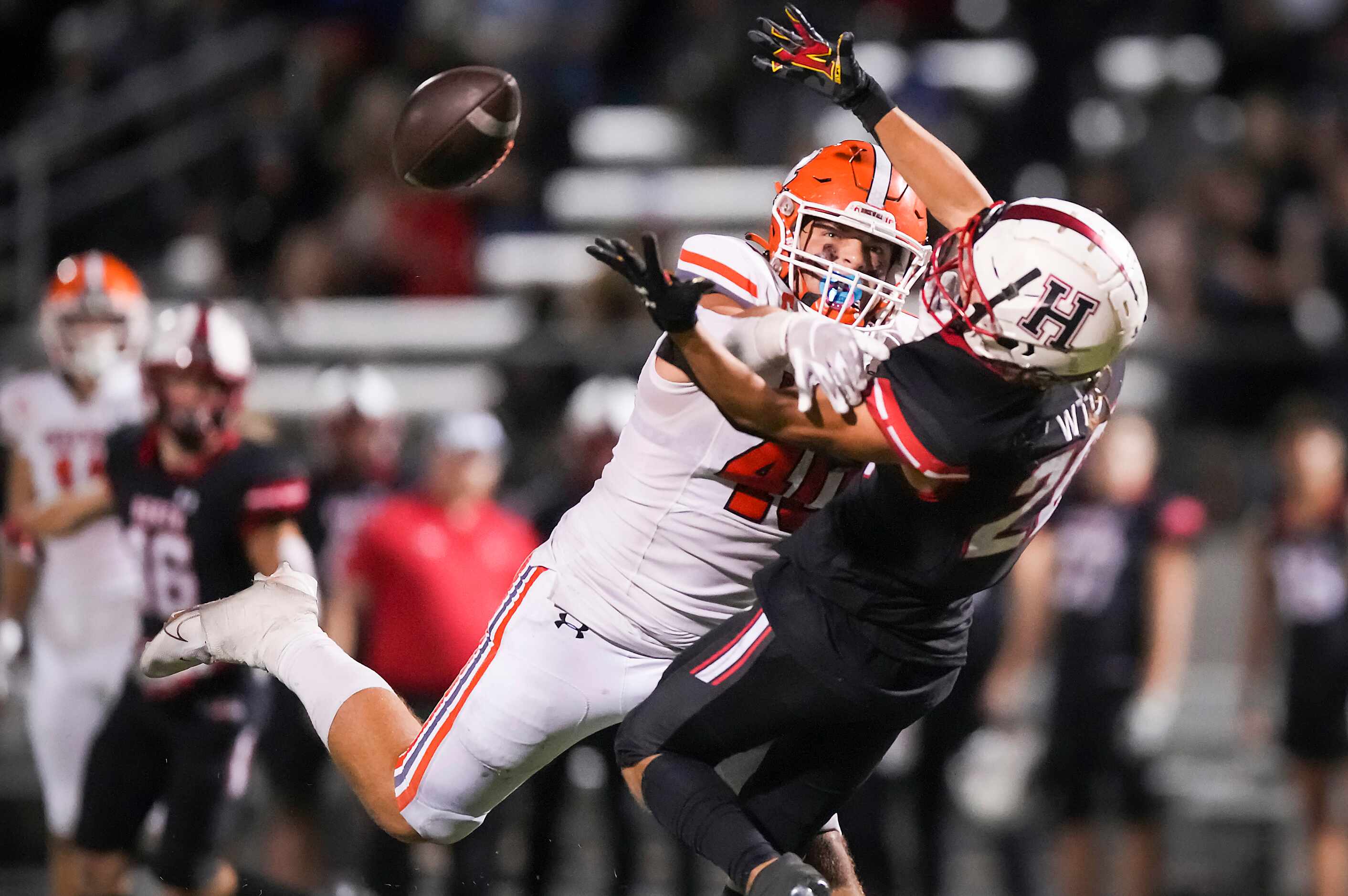 Heath defensive back Layne Horak (20) breaks up a pass intended for Rockwall tight end...