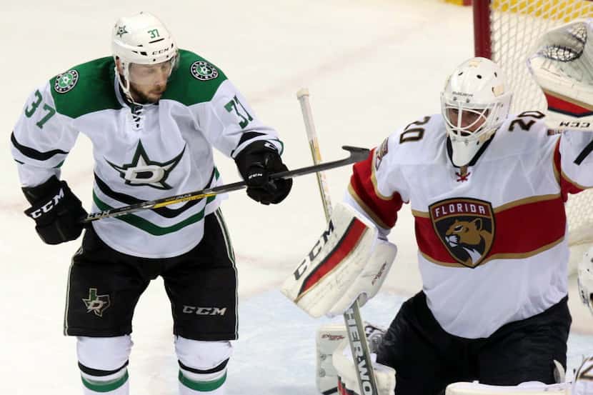 Florida Panthers goalie Reto Berra, right, makes a save on a shot deflected by Dallas Stars'...
