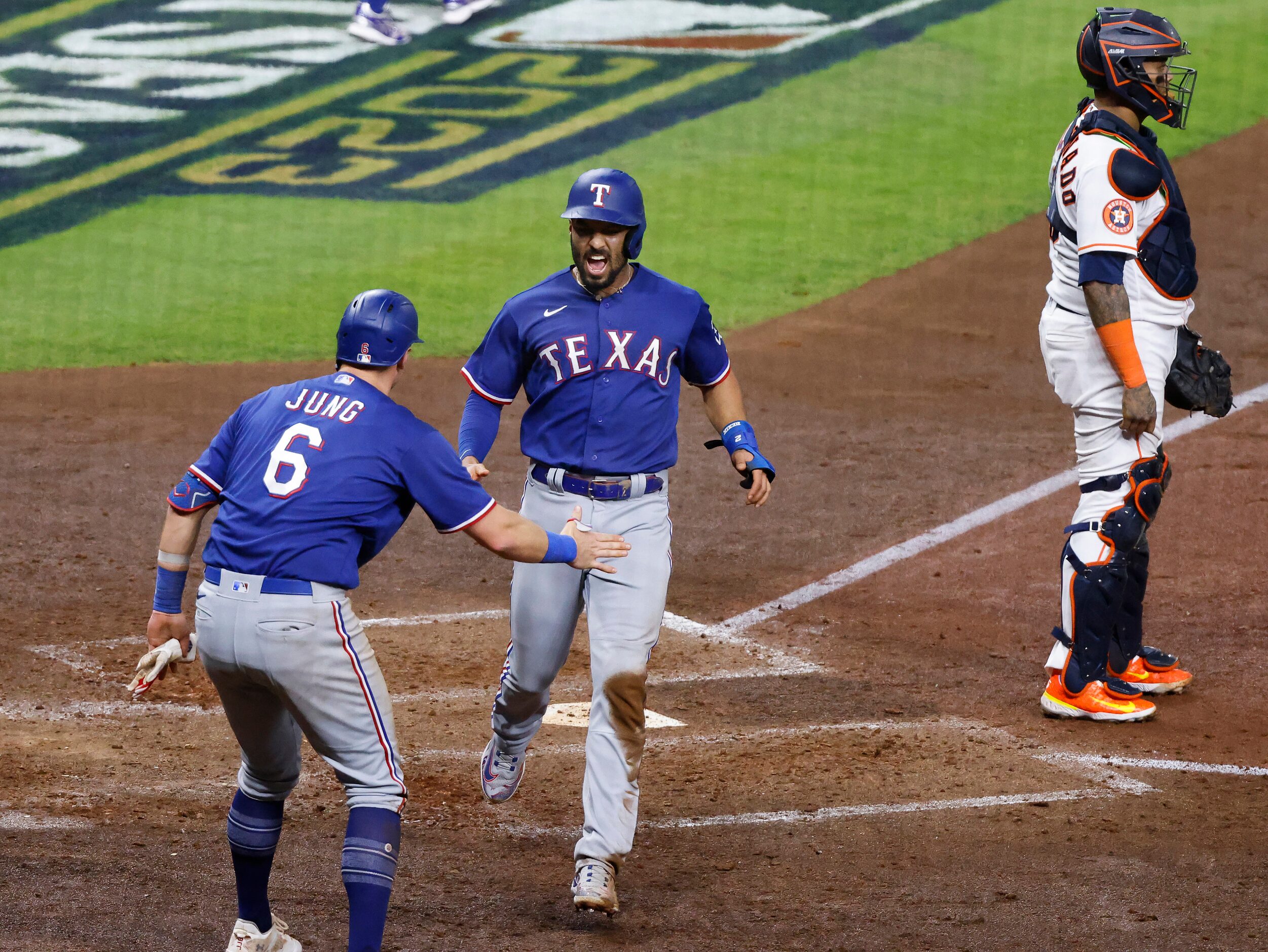 Texas Rangers Josh Jung (6) and Marcus Semien (2) scored on Evan Carter’s double during the...